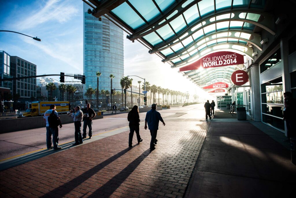 A shot of the front of the San Diego Convention Center in the Morning as morning light shines down the sidewalk.