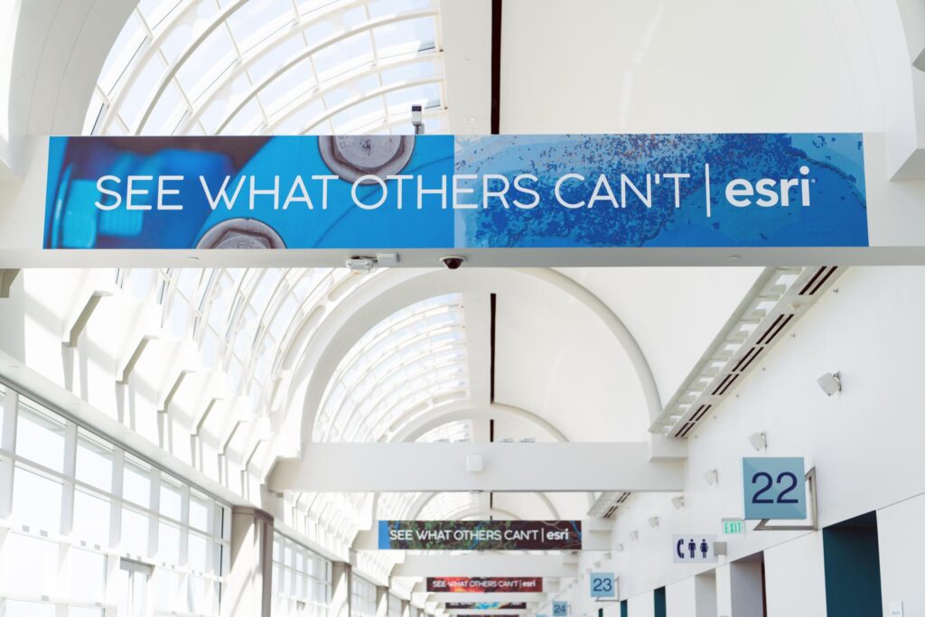 Indoor hall at teh SDCC with banner reading "see what others can't esri"
