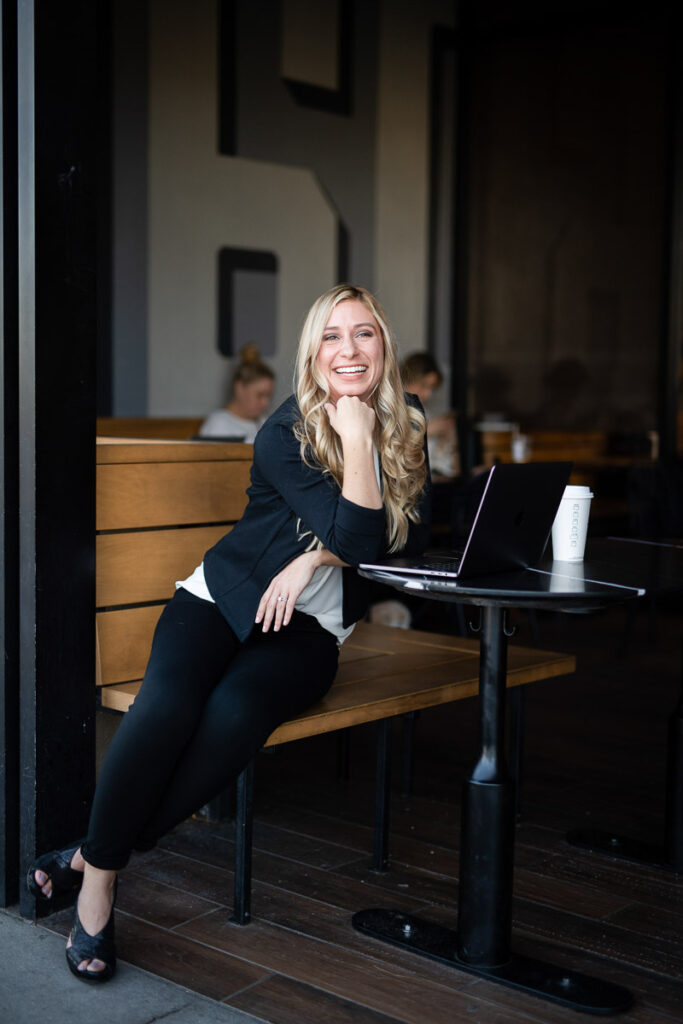 Woman in a business casual outfit, sitting down and posing for a branding photo