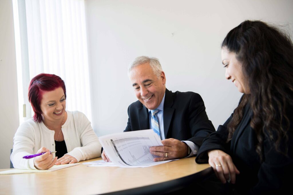 Three people looking at a document together