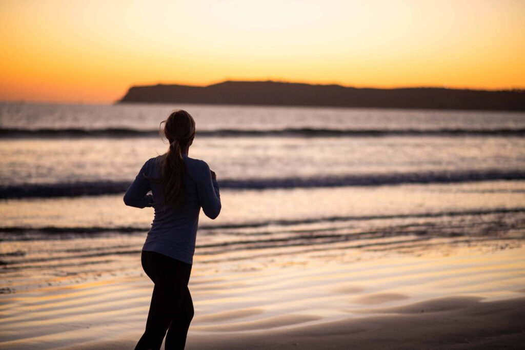 Woman jogging at a beach shore