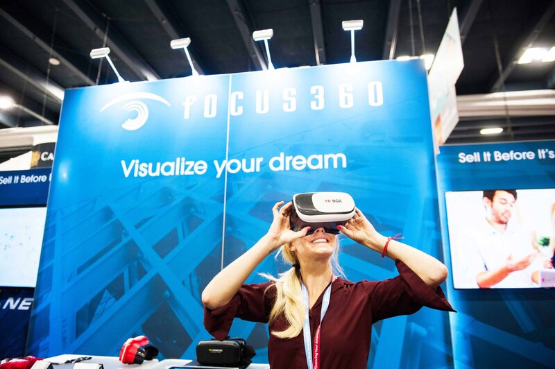 A woman engages with a virtual reality headset at a lively event